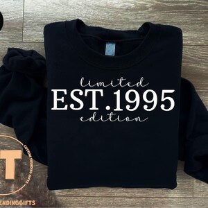 May include: Black sweatshirt with white text that reads "limited EST. 1995 edition".