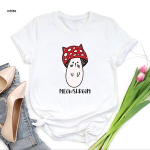 a white shirt with a red bow on it