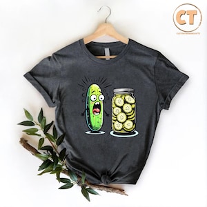 a t - shirt with a pickle and a jar of pickles on it