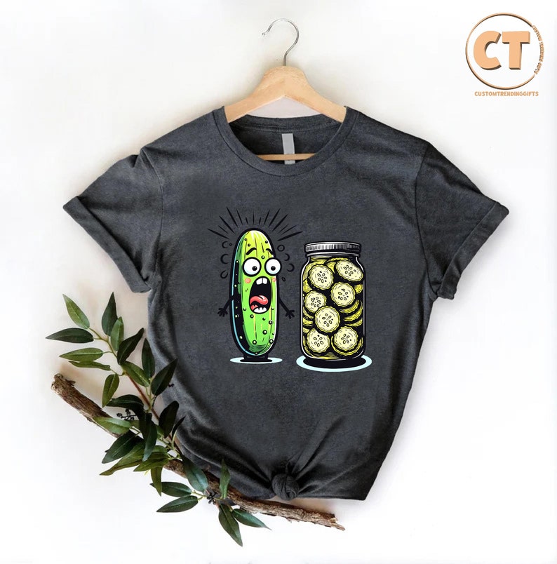 a t - shirt with a pickle and a jar of pickles on it