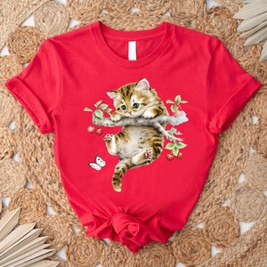 a red shirt with a cat on it