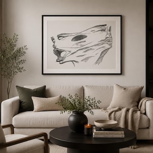 May include: A framed horizontal wall art print featuring a charcoal-style sketch of two faces in profile, one appearing to be screaming or shouting, set against a light beige background within a thin black frame hanging above a sofa.