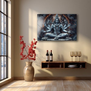 May include: A rectangular wall art print featuring a blue-toned, multi-armed deity sitting in a meditative lotus position. The figure is surrounded by a glowing orange circular aura and dark, textured stone-like elements in the background.