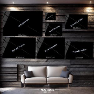 May include: A collection of seven rectangular black wall art panels displayed in various sizes, including 100x150 cm, 90x140 cm, 80x120 cm, 70x110 cm, 60x90 cm, 50x70 cm, and 30x42 cm, positioned above a sofa measuring 200 cm in width.