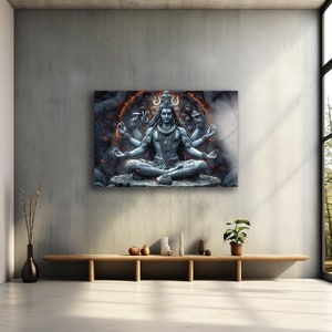 May include: A rectangular wall art print featuring a detailed blue-toned illustration of the deity Shiva in a meditative lotus position. The figure has multiple arms, a crescent moon in the hair, and is surrounded by a glowing orange circular aura.