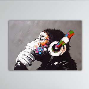 May include: A black and white painting of a monkey wearing colorful headphones. The monkey is sitting with its chin on its hand, looking thoughtful. The background is a light gray.