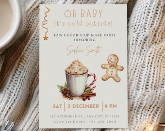 May include: A festive invitation card with the text "OH BABY It's cold outside!" features a watercolor illustration of a hot chocolate, gingerbread man, and candy cane. The card is surrounded by a knitted blanket, pine cones, and a mug of hot drink.