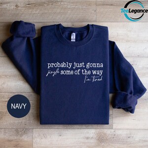 Navy sweatshirt with white text on it.