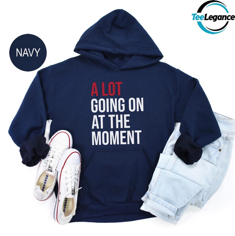 a sweatshirt with a pair of white tennis shoes and a pair of white tennis shoes
