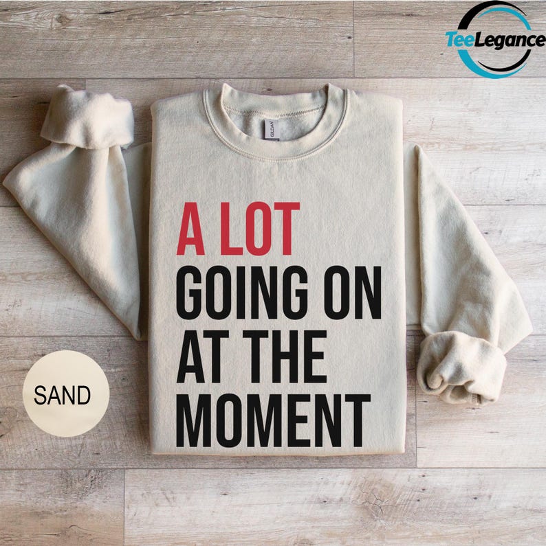 a sweater with a slogan on it sitting on a wooden floor