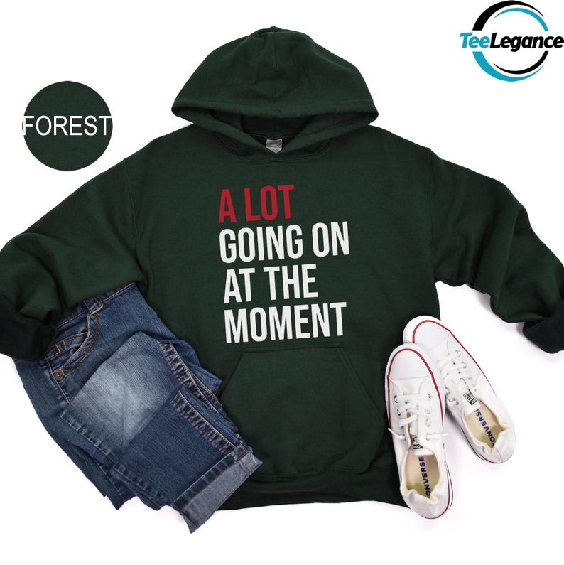 a green sweatshirt with the slogan a lot going on at the moment