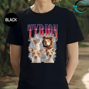 a woman wearing a black t - shirt with two dogs on it