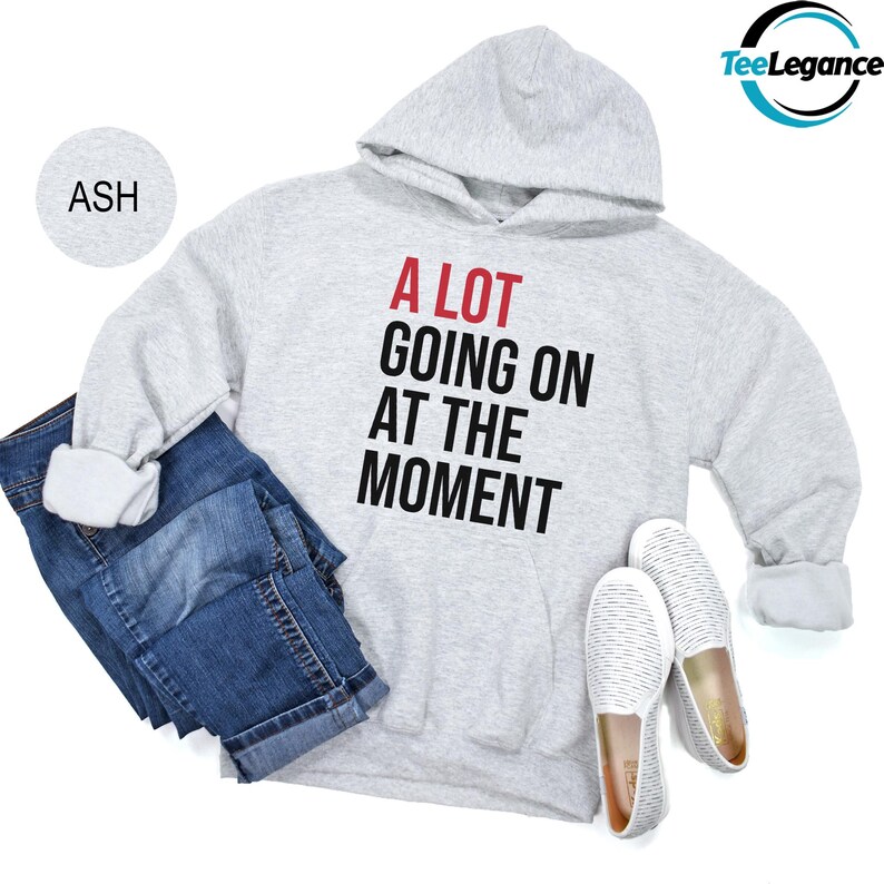 a sweatshirt, jeans, sneakers and a pair of slippers