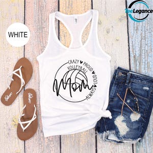 May include: White tank top with a black graphic of a volleyball and the text "Crazy Volleyball Mom Always Proud Loud".