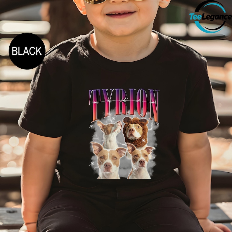 a little boy sitting on a bench wearing a t - shirt with a picture of