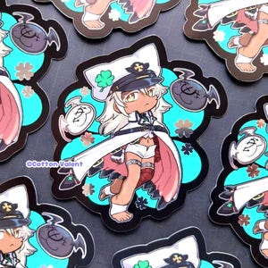 May include: A collection of anime-style stickers featuring a character in a white sailor hat and coat, with a black and gold emblem. The character is set against a teal and black floral background, with a fish-shaped design. The stickers have the text "Cotton Valent".