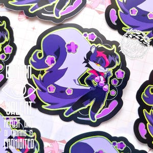 May include: A collection of stickers featuring a stylized skunk character with purple, black, and pink accents. The skunk has a confident pose, surrounded by floral and cloud-like shapes. The stickers have a black border and a neon green outline.
