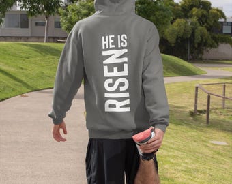 May include: A gray hooded sweatshirt with the text "HE IS RISEN" printed vertically down the back.