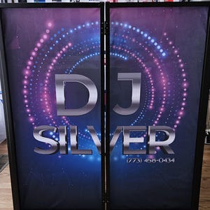 May include: A black DJ booth with a silver DJ Silver logo and a blue and purple background with white dots. The phone number (773) 458-0434 is printed on the booth.