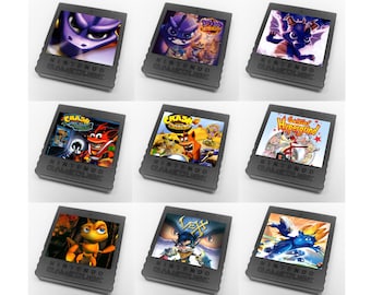 Op de afbeelding: Negen Nintendo GameCube-gamecartridges worden getoond, elk met kleurrijke game-art. De cartridges zijn donkergrijs en bedrukt met "NINTENDO GAMECUBE". De game-art toont personages en titels zoals "Crash Bandicoot" en "Spyro".