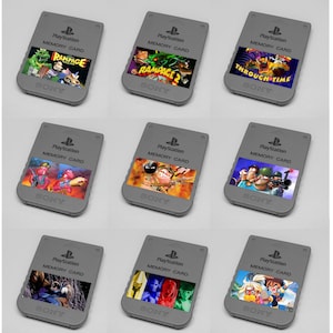 May include: Nine gray PlayStation memory cards, each with a different game cover art. The games include "Rampage," "Through Time," and others. The cards have the PlayStation logo and "Memory Card" printed on them.