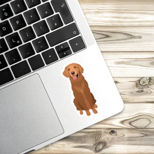 K&ouml;nnte beinhalten: Ein Aufkleber mit einer Cartoon-Illustration eines Golden Retriever-Hundes, der mit herausgestreckter Zunge sitzt. Der Hund ist braun mit einer wei&szlig;en Brust und einer schwarzen Nase.