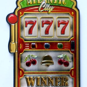 May include: A red, gold, and green slot machine with the words "Atlantic City" on the top and "Winner" below the three 7s. The slot machine has a gold lever on the left side and a bell, cherries, and gold coins on the bottom.