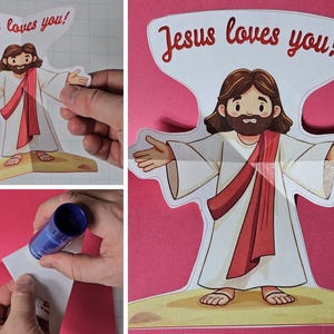 May include: A paper cutout of Jesus with outstretched arms, wearing a white robe and a red sash. The text "Jesus loves you!" is above the figure. The image is on a pink background.