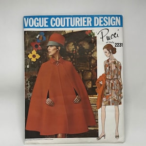 May include: A vintage Vogue Couturier Design sewing pattern featuring a Pucci of Italy design. The cover shows a woman in a red cape and hat, and another in a geometric print dress. The pattern number is 2231.