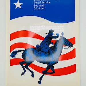 May include: A 1973 United States Postal Service Souvenir Mint Set cover. The design features a blue and white star, red and white stripes, and a blue illustration of a rider on a horse blowing a horn.