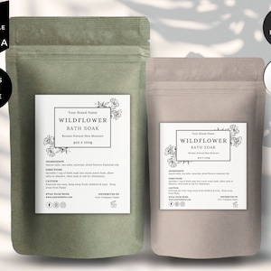 May include: Two brown paper bags with labels for Wildflower Bath Soak. The labels are white with black text and a floral design. The text on the labels includes "Your Brand Name", "Wildflower Bath Soak", "Retains Natural Skin Moisture", "402 g / 100g", "Ingredients", "Directions", "Caution", "Distributed By", "Your Company Name", and "Your Social Media".
