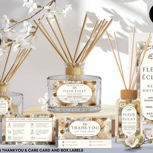 Könnte beinhalten: Ein klarer Glas-Reed-Diffusor mit Holzstäbchen, beschriftet mit "Fleur Éclat". Das Bild enthält eine Box, Pflegehinweise und eine Dankeskarte. Der Diffusor enthält Trockenblumen und ist mit 120ml beschriftet.