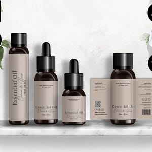 May include: A product mockup showing four brown glass essential oil bottles with black caps and labels. The labels read "Essential Oil" and "Oatmeal & Honey". A label with ingredients and directions is also included in the image.