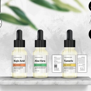 May include: Three glass bottles with droppers containing oil serums labelled "Kojic Acid", "Aloe Vera", and "Tumeric". The bottles are on a white marble shelf. The labels are white with black text and are surrounded by a thin black border. The bottles are 30ml, 60ml, and 120ml.