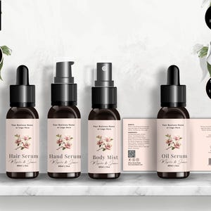 May include: Four brown glass bottles with black droppers and spray tops are displayed on a white shelf. Each bottle has a label with a floral design and the text "Hair Serum", "Hand Serum", "Body Mist", and "Oil Serum". The image also includes text that says "Editable in Canva" and "Bonus Items Inside".