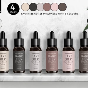 May include: Six glass bottles with dropper tops, labeled "BARE SILK Oil Blank Serum", in six different colors: beige, gray, brown, pink, light brown, and dark brown. The bottles are arranged in a row on a marble surface. The bottles are available in three sizes: 1 ounce, 2 ounces, and 4 ounces.