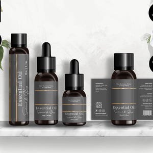 May include: A selection of essential oil bottles with dark grey labels and black caps. The labels display "Essential Oil" and "Sandalwood & Honey". The image also includes a label with ingredients and directions. The bottles are in sizes of 10ml and 15ml.