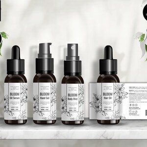 May include: Four black bottles with white labels and floral designs. The labels read "Bloom Oil Serum", "Bloom Hand Gel", "Bloom Body Mist", and "Bloom Hair Oil".
