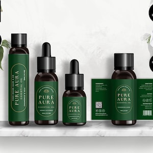 May include: Four glass bottles with dropper tops and labels. The labels are green with gold lettering and feature the text "Pure Aura Essential Oil". The bottles are arranged in a row on a white shelf.