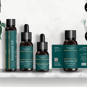 May include: Four essential oil bottles with dark brown glass and black caps are displayed on a white shelf. The bottles have teal labels with gold accents and the words "Essential Oil". The image also includes a label with ingredients and directions.