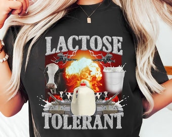 May include: Black t-shirt with a graphic of a milk carton exploding with cows and airplanes around it. The text "Lactose Tolerant" is below the graphic.