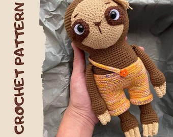 May include: Crochet pattern for a brown sloth wearing yellow and orange overalls. The sloth is holding a small orange button. The pattern is available as a PDF download.