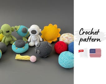 May include: A collection of colorful, crocheted space-themed toys, including an astronaut, sun, planets, and a rocket. The toys are in various colors such as yellow, blue, red, and green. The image also includes the text "Crochet pattern".