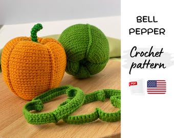 May include: Crocheted orange pumpkin and green bell pepper with green stems. Two green crocheted rings are in the foreground. The text "BELL PEPPER Crochet pattern" is on the right side of the image.
