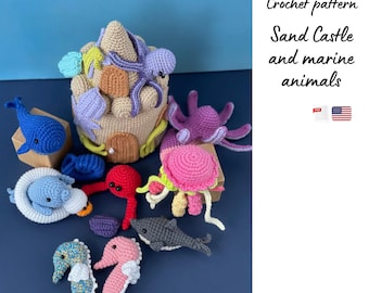 May include: A collection of crochet marine animals and a sandcastle. The sea creatures include a blue whale, octopus, seahorses, and a shark. The sandcastle is beige with purple and orange accents. The text on the image says "Crochet pattern Sand Castle and marine animals".