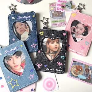 May include: Four photo card holders in denim and pink fabric with heart-shaped cutouts. The denim holders have the word "Starlight" and star accents. The black holder says "Sweet love". Each holder has a photo inside.