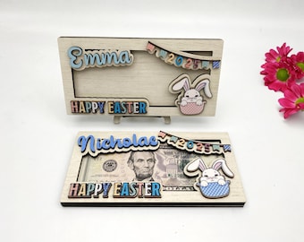 May include: Two wooden picture frames with a bunny rabbit design. The top frame says "Emma 2025 Happy Easter". The bottom frame says "Nicholas 2025 Happy Easter".