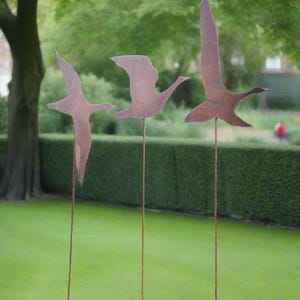 Three large rusty Flying Geese Garden Art on poles measuring 25 x 16.5 cm for garden/outdoor.