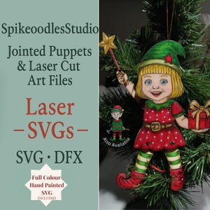 May include: A hand-painted Christmas ornament of an elf girl with a green hat and red dress holding a star wand and a gift. The ornament is hanging on a Christmas tree. The text "SpikeoodlesStudio" and "Laser - SVGs-" are visible.