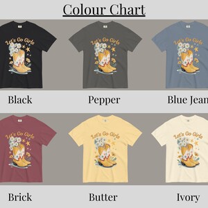 May include: A color chart displays six t-shirts in various colors: black, pepper, blue jean, brick, butter, and ivory. Each shirt features a graphic of a yellow cowboy boot with flowers and the text "Let's Go Girls".